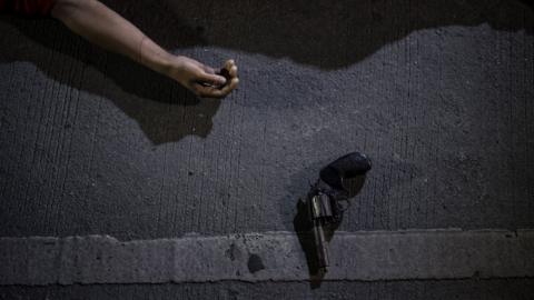 The body of an alleged drug dealer killed during a police anti-drug operation is seen on the ground in Manila on August 18, 2017.