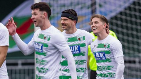 TNS players celebrate third goal against Met