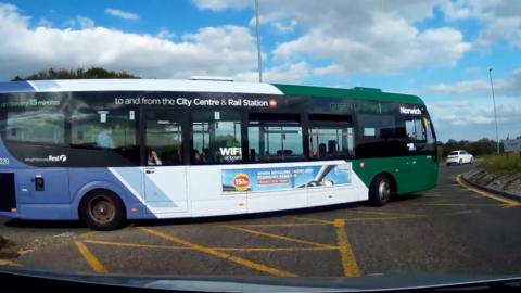 Bus pulling on to a roundabout