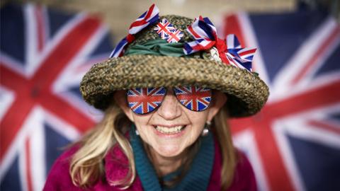 A royal fan, Sally Scott, poses on the Mall outside Buckingham Palace ahead of the Coronation.