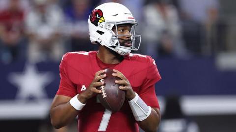 Arizona Cardinals quarterback Jacoby Brissett preparing to throw the ball