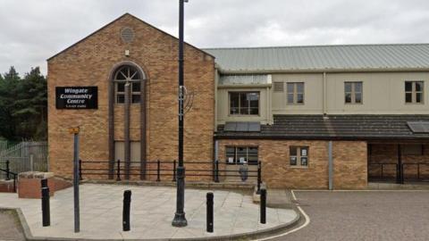 Wingate Community Centre is a two-storey building. It has a large sign attached to the brick work reading "Wingate Community Centre".