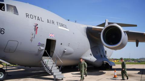 The aircrew of a Boeing C-17 Globemaster military transport aircraft, which is due to take part in the Royal Air Force flypast on May 5, during events marking the 80th Anniversary of VE Day, check the aircraft at RAF Brize Norton, Oxfordshire.