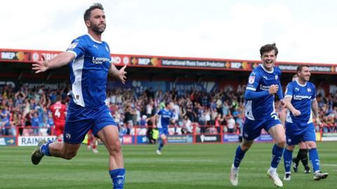 Will Grigg celebrates scoring for Chesterfield at Accrington