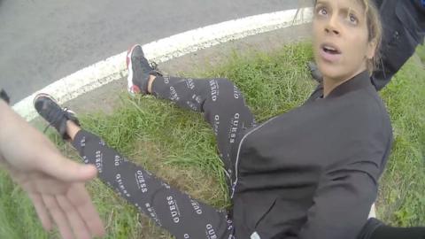 Nadine Buzzard-Quashie is on the floor with her arms held behind her back during her arrest