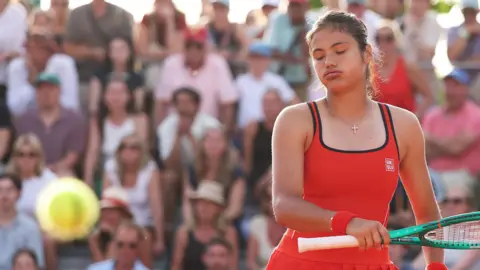 Emma Raducanu sighs as she watches the ball go past her for a winner at the 2026 French Open