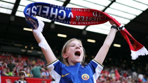 A Chelsea fan shows support from the stands prior to the Barclays Women's Super League match