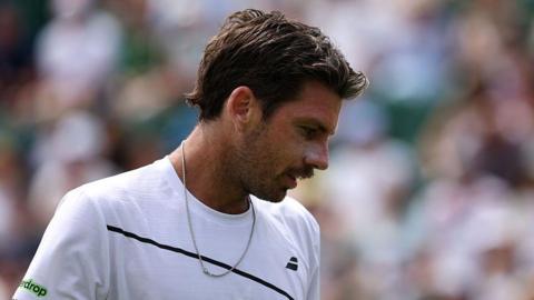 Cameron Norrie looks down during his first-round match