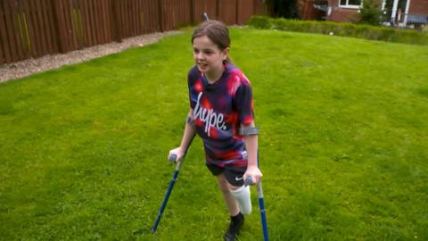 Keeley playing football in her garden