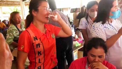 A woman in Thailand crying amid a crowd