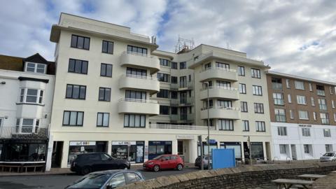 St Margaret’s Court, a cream building with windows and balconies