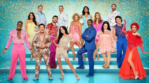 All the strictly contestants on stairs with a green glittery background