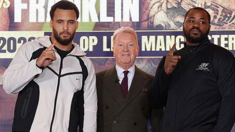 Moses Itauma stands next to Frank Warren and Jermaine Franklin at a news conference