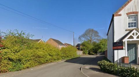 Mill Lane Huthwaite - a small road in a relatively new estate which runs alongside a hedge before becoming a tree and hedge lined country lane.