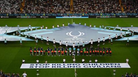 A banner saying "stop killing children, stop killing civilians" is displayed during the Super Cup final 