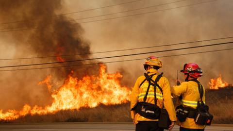 Firefighters work to contain wildfire flames during the Canyon Fire No 2 in Anaheim Hills, California