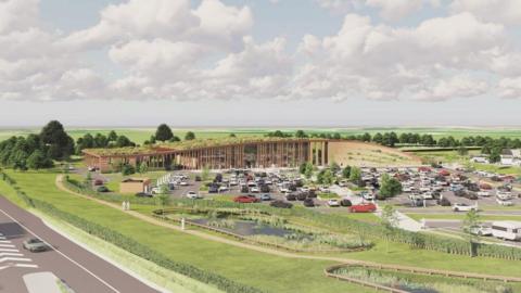 An artist's impression of how the services at Kirkby Hill (x) could look - with a grassy area in front and a wooden screened services building with a green roof, and a car park. The motorway runs along the side.