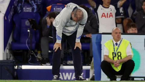 Ange Postecoglou stands dejected on the touchline