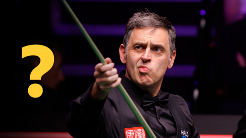 Ronnie O'Sullivan looking at his cue after playing a shot