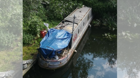 A 57ft narrowboat in a river