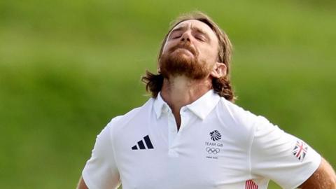 Tommy Fleetwood closes his eyes and tilts his head back in disappointment during the final round of the men's Olympic golf tournament