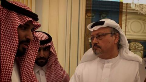 Jamal Khashoggi (right) with two unidentified people