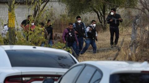 Police officers work at a crime scene where gunmen killed at least 13 Mexican police officers in an ambush, in Coatepec Harinas, Mexico March 18, 2021