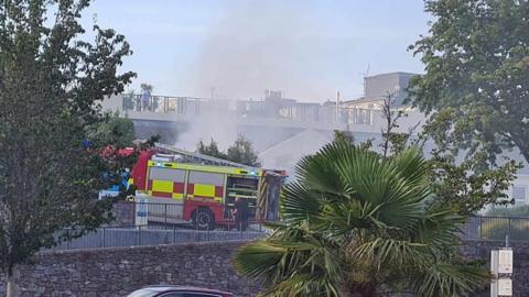 Firefighters tackling a blaze in a car park