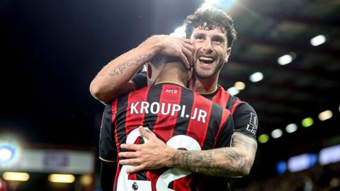 Eli Junior Kroupi of Bournemouth celebrates with Marco Senesi.