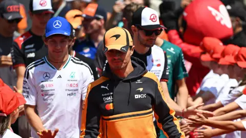 McLaren's Lando Norris and Mercedes' Kimi Antonelli walk out for the drivers' parade before the Hungarian Grand Prix