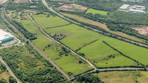 An aerial shot of a large valley with trees