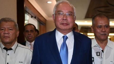 Former Malaysian PM Najib Razak (centre) arrives in court in Kuala Lumpur