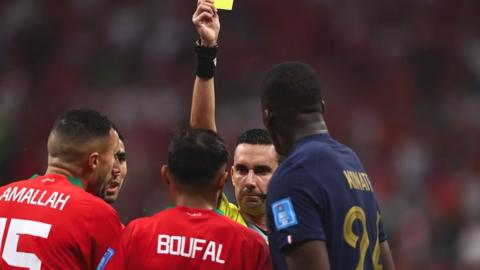 Mexican referee Cesar Ramos books Morocco's Sofiane Boufal during Wednesday's World Cup semi-final against France