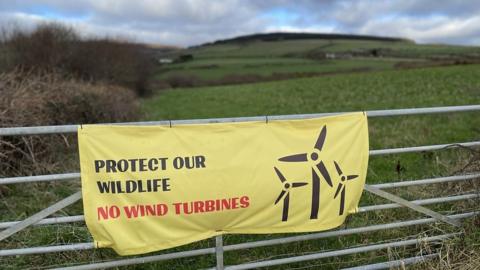Banner objecting to wind turbines with the slogan Protect Our Wildlife