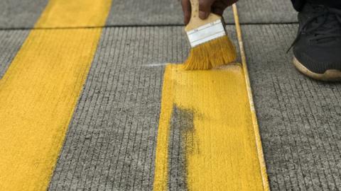 Man painting parking lines