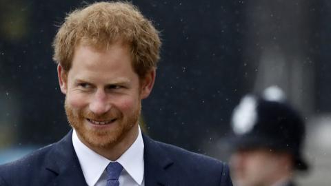 Prince Harry and police officer wearing helmet