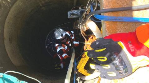 A man down a well in West Mersea, Essex