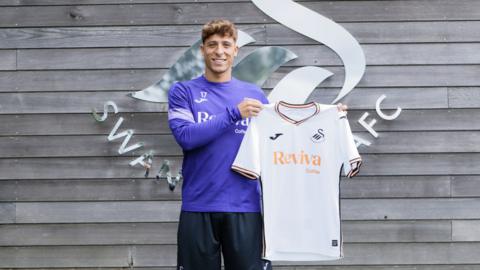 Swansea City's Goncalo Franco poses with a shirt