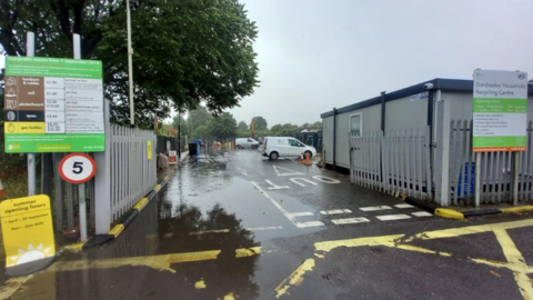 The entrance to a household recycling centre on a cloudy day