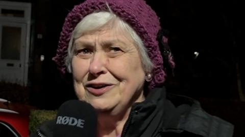 A woman with a purple hat