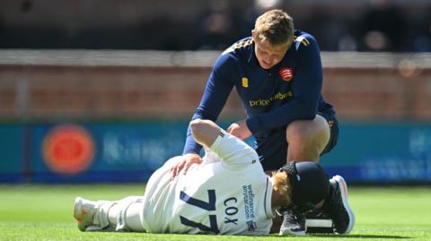 Jordan Cox receives treatment from physio
