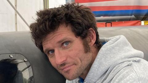 A close-up image of Guy Martin, who is wearing a grey hoodie 