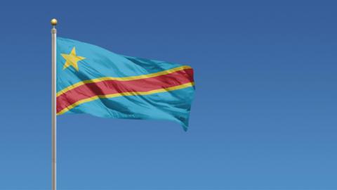 Democratic Republic of Congo flag hangs on a flagpole and waves in the wind