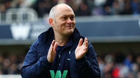 Alex Neil applauding the Millwall fans after a match