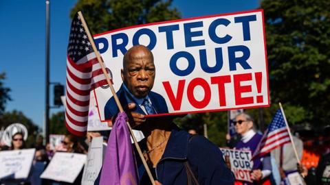 People protest outside the US Supreme Court over the Voting Rights Act case
