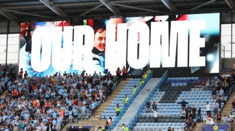 A screen at the CBS Arena displays the message 'Our Home'