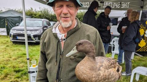 Mark Colyer and his emotional support duck Dog