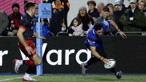Henry Arundell touches the ball to the floor to score a try for Bath