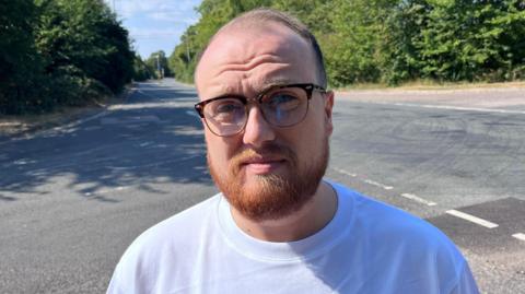 Councillor George Holt stands beside Main Road outside Farningham Road railway station