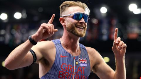 Josh Kerr celebrates winning world indoor 3,000m gold